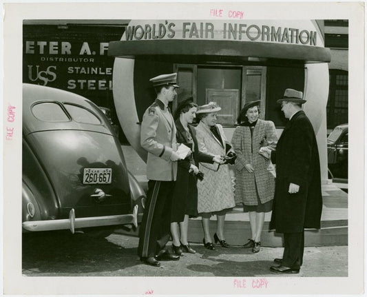 Information Booths - Attendant giving man directions in front of booth shaped like Perisphere