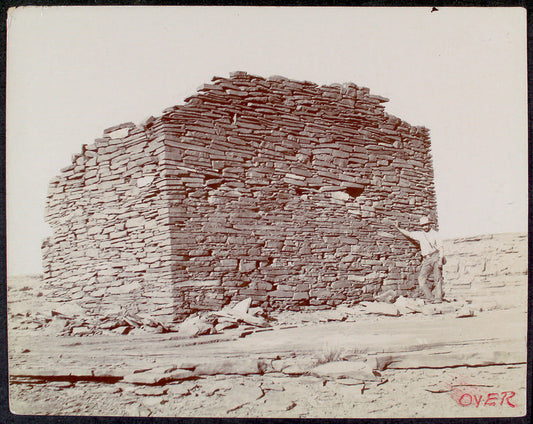 Front of fort. Line of loopholes on level with and below the waist of the man.